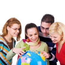 Group of students holding a world globe